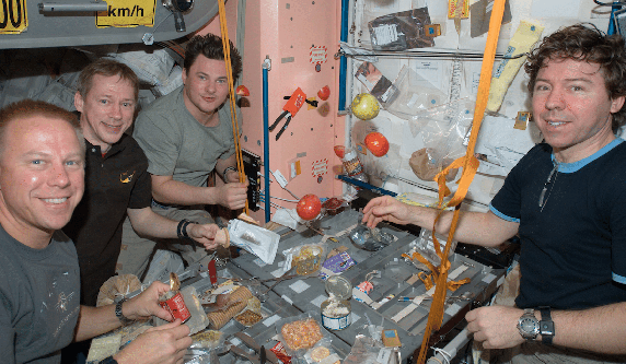 astronauts eating hot sauce in space